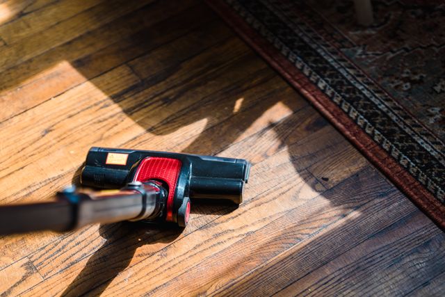 Close-up of a vacuum cleaner on wooden flooring