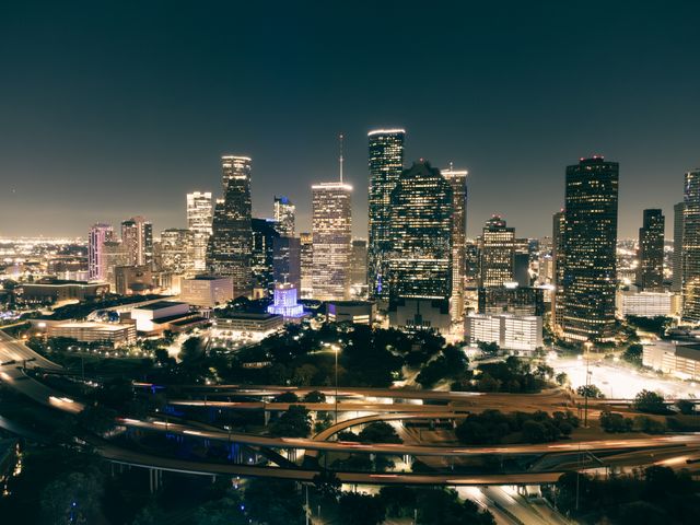 aerial view of Houston's illuminated skyline featuring skyscrapers and highways at night