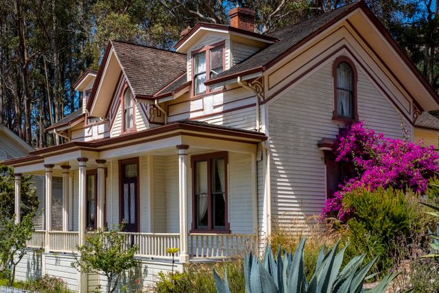 Victorian house surrounded by vibrant gardens and trees