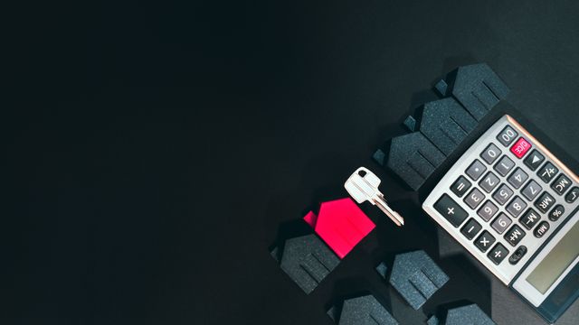 calculator, houses, and a key