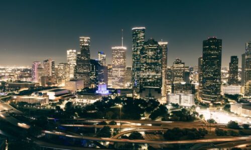 aerial view of Houston's illuminated skyline featuring skyscrapers and highways at night
